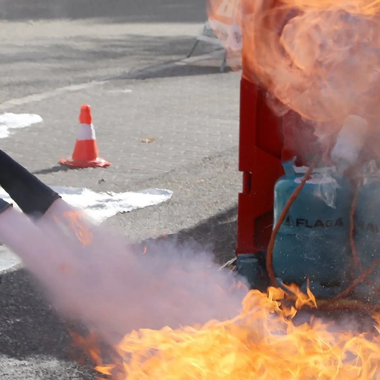 Instructor showing how to use a foam extinguisher